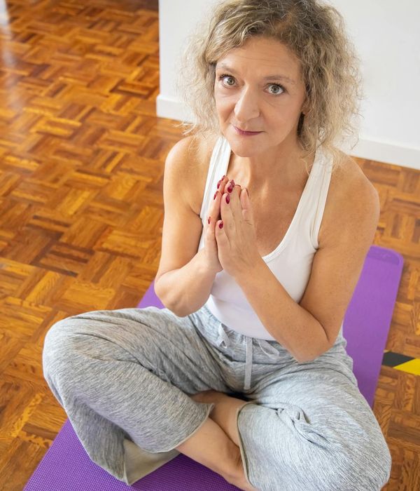 Woman practicing gentle yoga for inner balance indoors